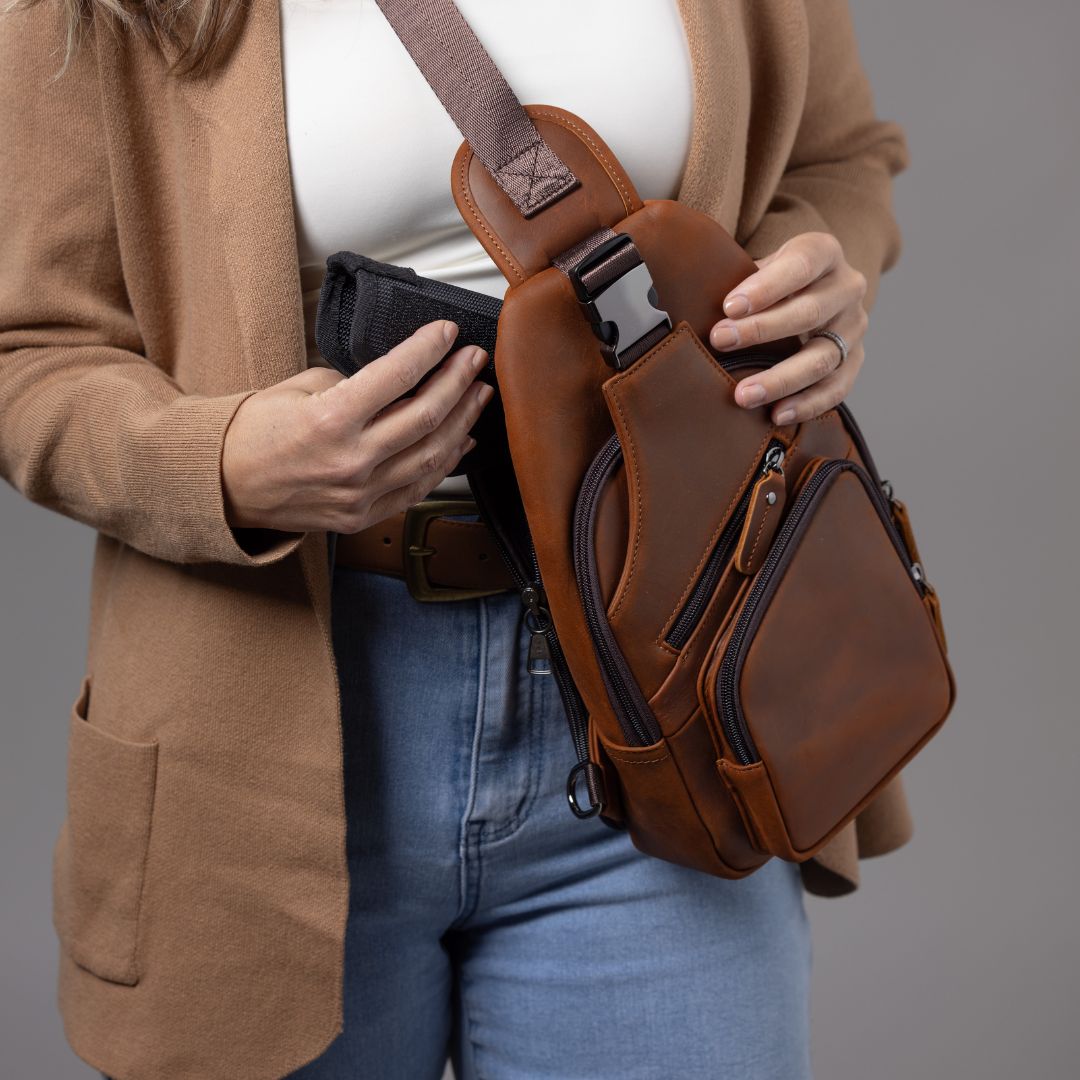 Concealed Carry Xander Leather Sling in Distressed Brown – worn by model 2