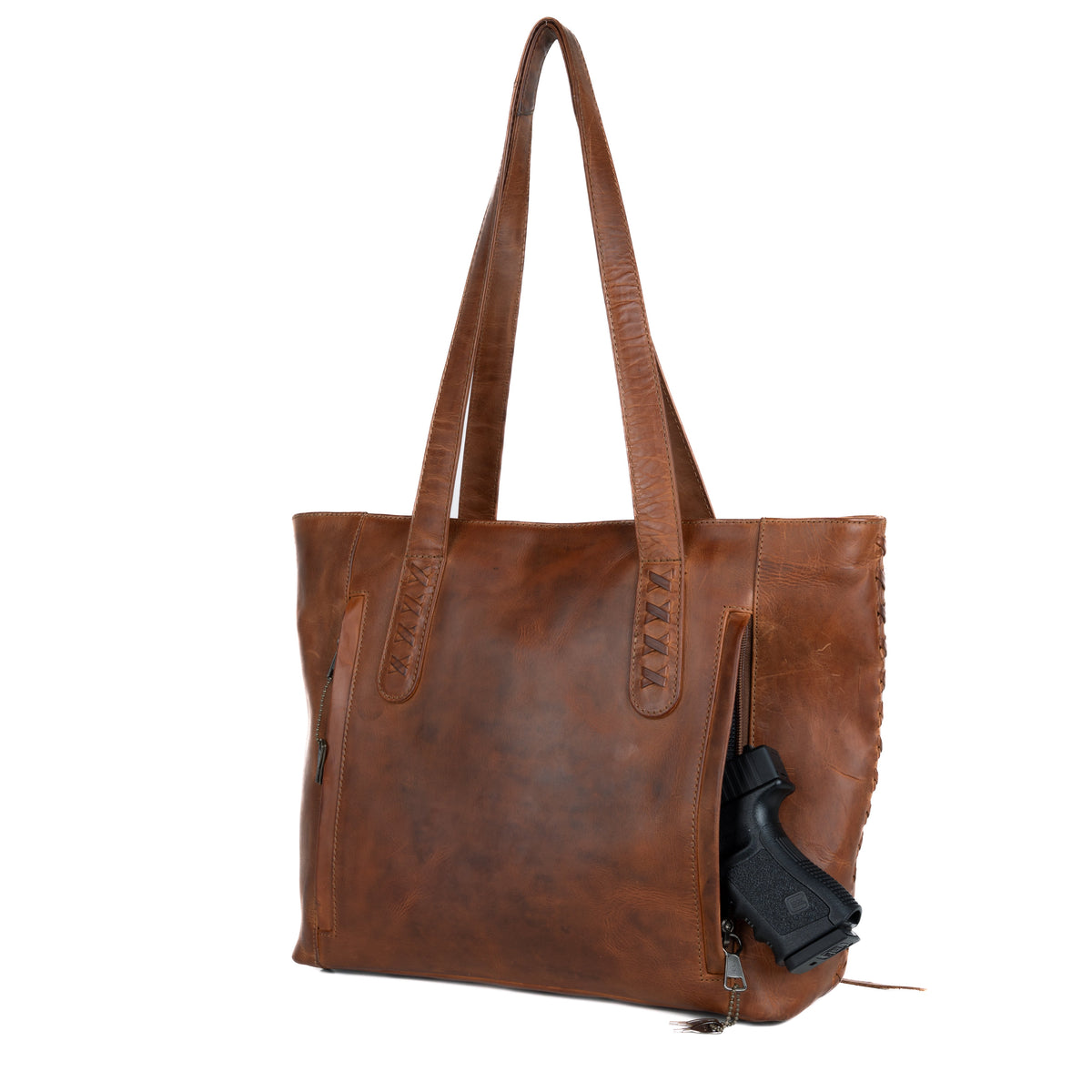 Concealed Carry Reagan Medium Leather Tote in Cognac – shown with handgun