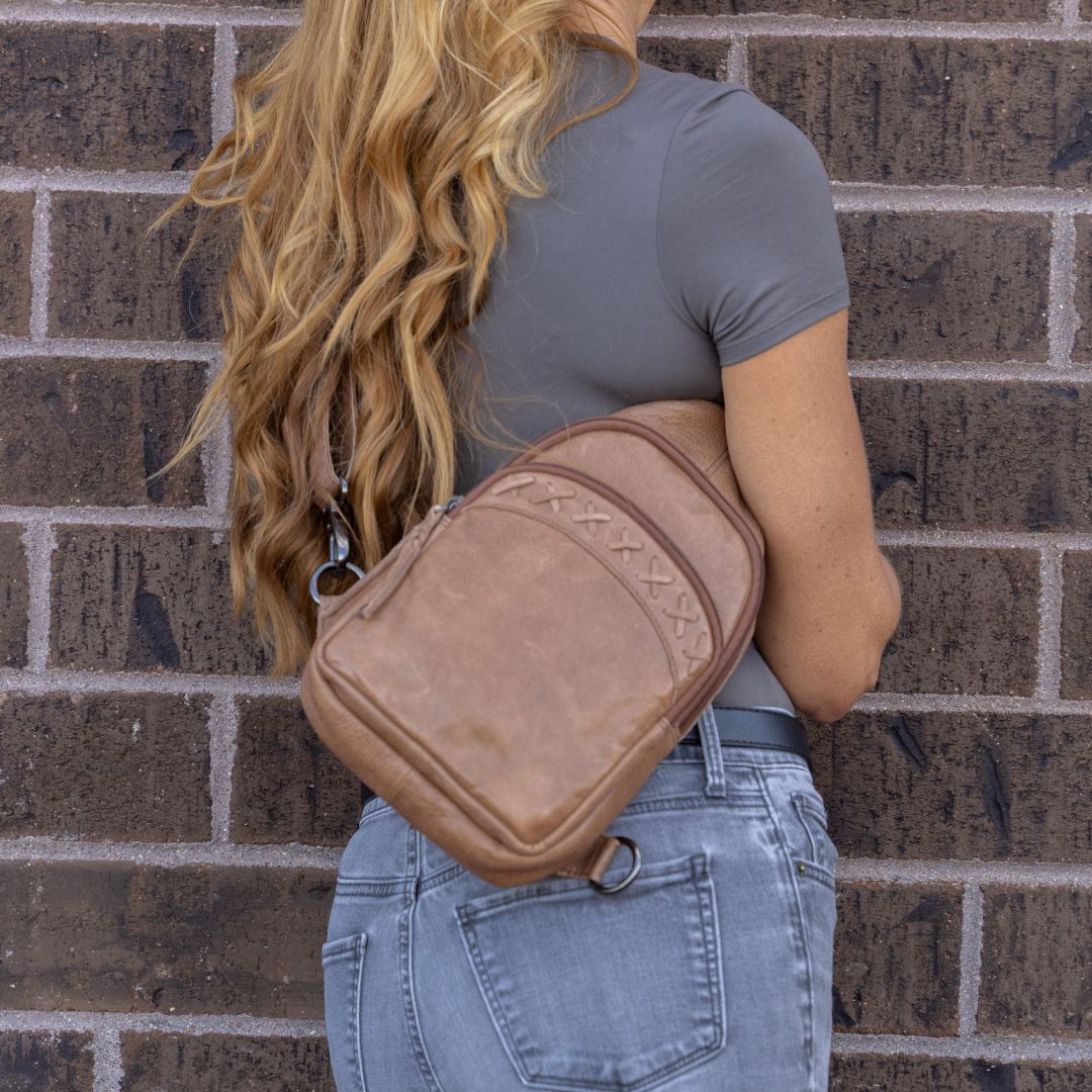 Concealed Carry Unisex Taylor Leather Sling Backpack in Cognac – worn by model 2