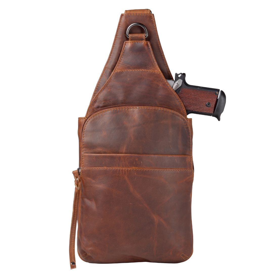 Concealed Carry Unisex Dakota Leather Sling in Cognac / Regular – shown with handgun