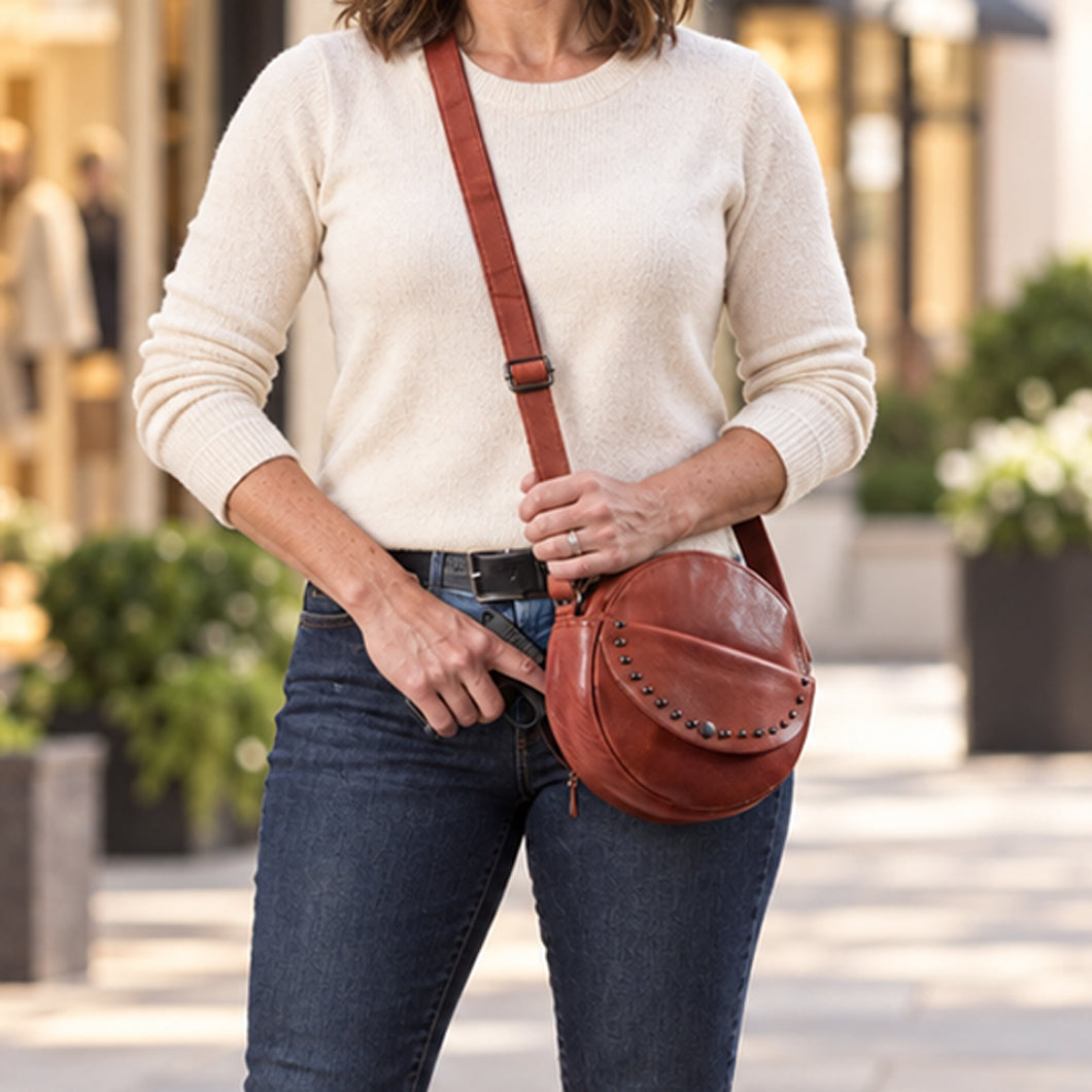 Women's Concealed Carry Mia Crossbody Purse in Cognac – worn by model